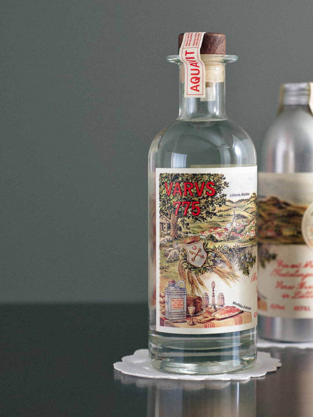 Decorated clear bottle standing on small pedestal against gray background, Varus 775 by Olssøn Barbieri, Lübbecke, Olssøn Barbieri / Varus Brennerei, Lübbecke, Germany